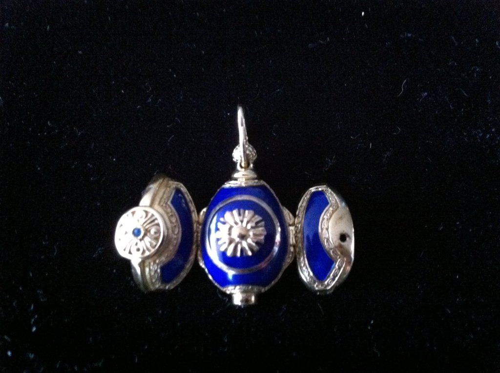 14 karat gold and enamel egg with religious saints: Eight penny weights total weight, no makers mark, but appears to be a finely crafted piece of jewelry. Tested for 14 karat gold. Faberge?