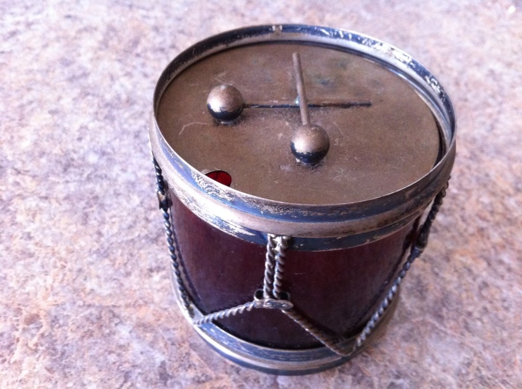 Sterling silver drum with a red ruby glass: Sterling silver drum with a red ruby glass. Will look after a quick polish. Resembles a civil war type drum, very deep red ruby glass. Craftsmanship is exceptional.