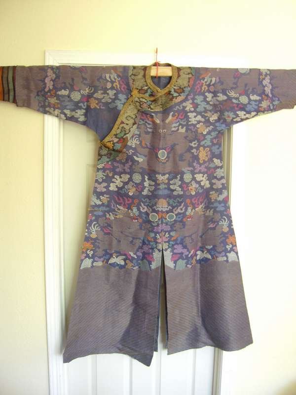 Chinese Kesi Dragon Robe, 19th century: Kesi Dragon Robe, China, 19th century, with a forefronting dragon amidst clouds interspersed with bats, twin fish, dragons, and cranes, above lishui borders to the bottom, on a blue ground. Size 6o" l