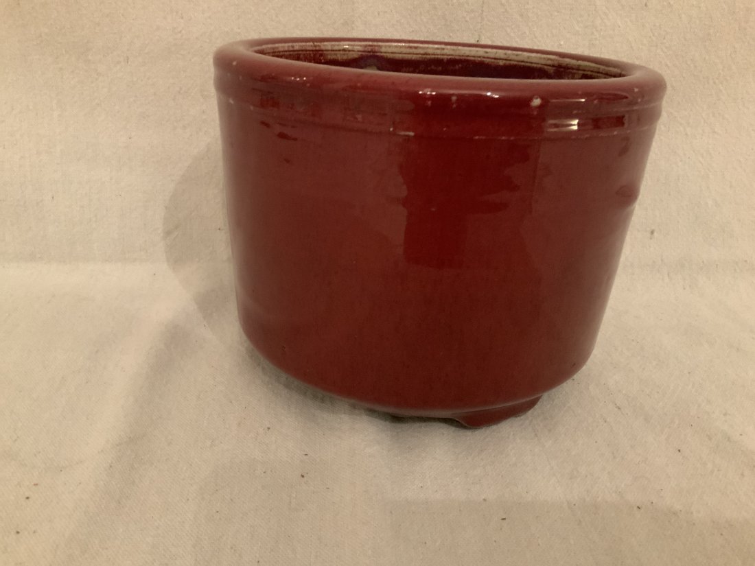 Chinese Oxblood Glazed Porcelain Footed Jardiniere: Chinese Oxblood Glazed Porcelain Footed Jardiniere. Height 6 inches. Diameter 8 inches.
