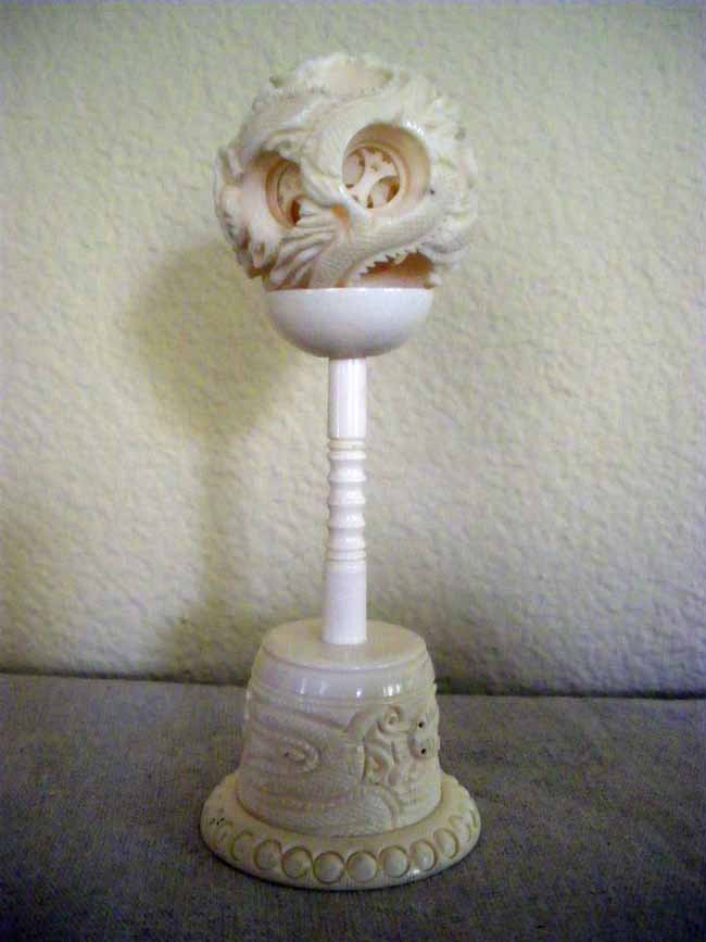 Chinese Carved Ivory Puzzle Ball on Stand: A Chinese carved ivory mystery puzzel ball on stand, measuring 5 ¾" tall.