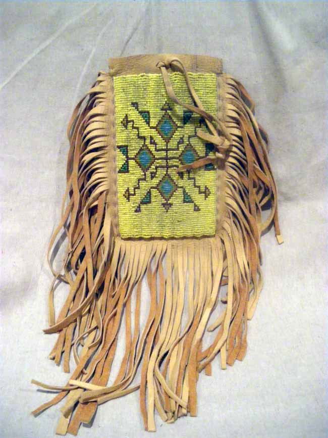 Native Greasy Yellow Beaded Buckskin Leather Hand: A fine Native buckskin bag with fringe & greasy yellow beaded front design, measuring 8" x 5".