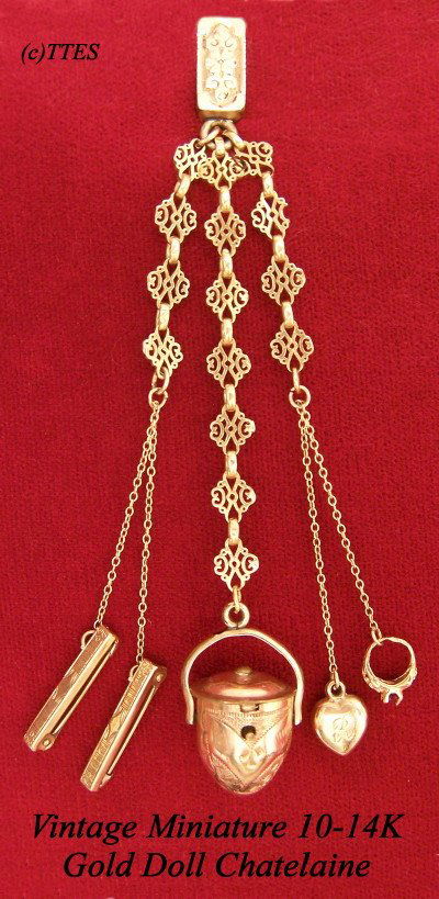 Vintage Miniature 10-14K Gold Doll Chatelaine: 5" in length, a charming late 19th to early 20th century little doll's or little girl's diminutive gold chatelaine with a tiny garnet or ruby stoned ring, two baby bar pins marked "10K," a heart shape