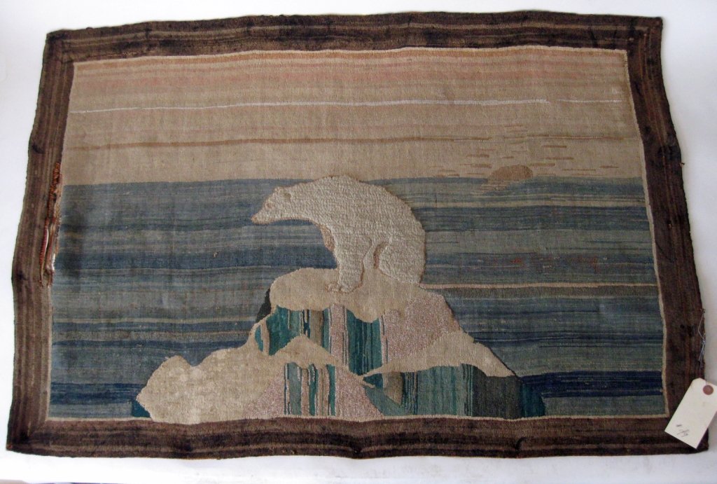 Antique labeled Grenfell polar bear rug, 26 by 40: Antique labeled Grenfell polar bear rug, 26 by 40 inches. Condition: rips and losses.
