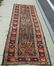 Old Caucasian Oriental long rug, 120 by 38 inches.