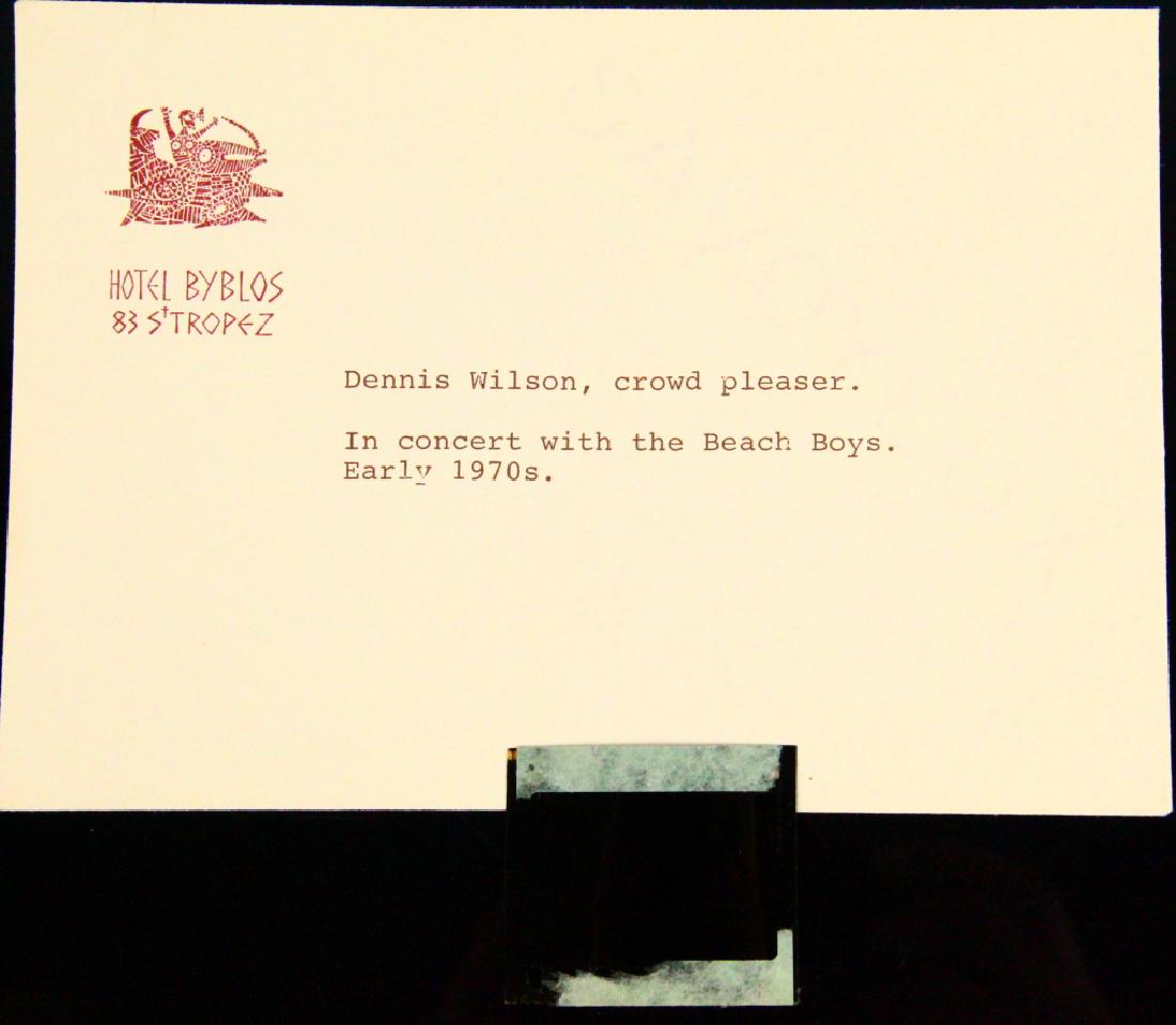 The Beach Boys Dennis Wilson NEVER SEEN Slide: "The Beach Boys" Dennis Wilson in Early 1970's Being Worshiped by Crowd NEVER BEFORE SEEN Photo Slide in Hotel Byblos Envelope W/Milton Love's Typed Notes on It - This slide is from the estate of Milt