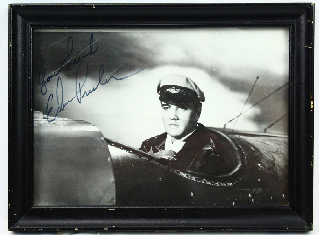 Elvis Presley Autographed 6" x 8" Photograph: Elvis Presley Autographed 6" x 8" Black & White Framed Photograph - This is an 6" x 8" black and white photograph of Elvis Presley. The photograph shows Elvis piloting an airplane, and is a still phot