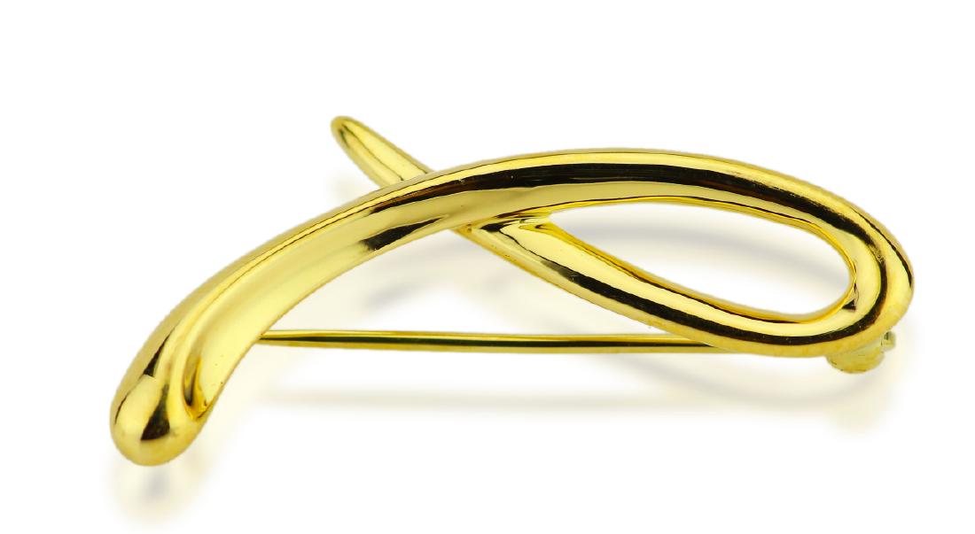 Tiffany & Co. Elsa Peretti 18K Ribbon Brooch: Tiffany & Co. Elsa Peretti Solid 18K Yellow Gold 1.25" Ribbon Brooch - This sleek and modern brooch was finely crafted by Tiffany & Co., and designed by Elsa Peretti. Elsa Peretti joined Tiffany in 19