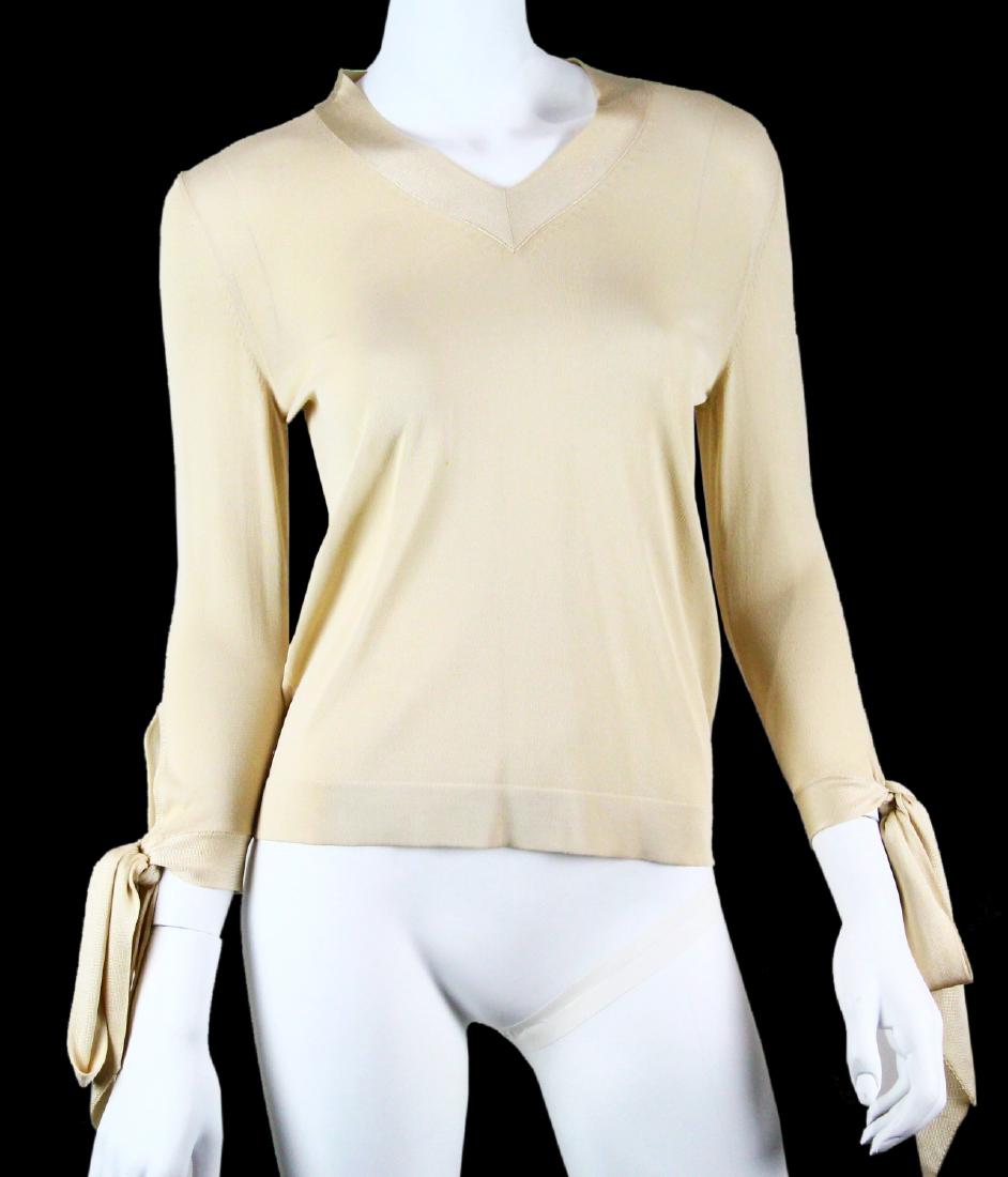 Hermes Ivory Rayon Sweater W/Tying Sleeves: Hermes Ivory Rayon Sweater W/Tying Sleeves - This beautiful sweater by Hermes is a lovely ivory color and is constructed of 100% rayon. The sweater is long sleeved, and ties at the cuff with 6" bows. 