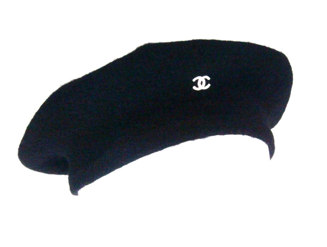 Chanel Vintage Black Felt Beret: Chanel Vintage Black Felt Beret - This classic black beret by Chanel is truly a wardrobe staple for any sophisticated lady. The beret has a classic black design with a white CC logo on the front. One 