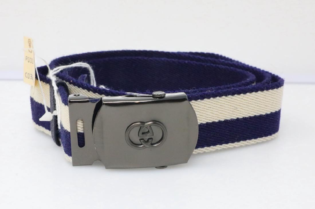 Gucci 1980s Navy & Ivory Canvas Belt New W/Tag: Gucci Vintage 1980s Reversible Navy & Ivory Canvas Belt W/GG Logo Slide Buckle New W/Tag - This vintage belt by Gucci is constructed of navy and ivory colored canvas. The belt has a striped design and