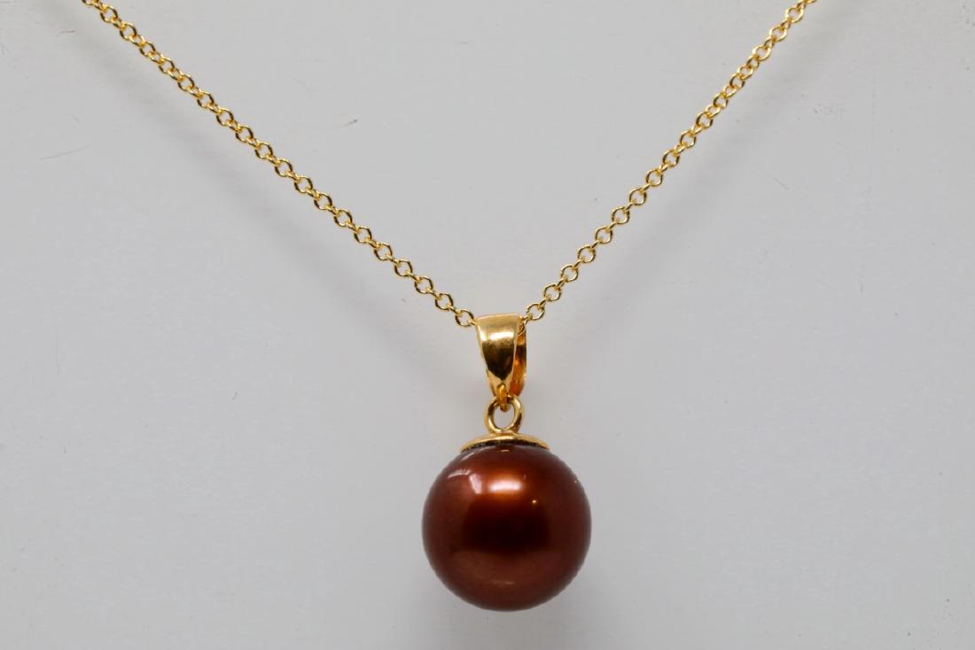 9.5mm Tahitian Chocolate Pearl & 18K Necklace: 9.5mm Tahitian Chocolate Pearl & Solid 18K Yellow Gold 18" Necklace - This beautiful necklace was finely crafted of solid 18k yellow gold and is comprised of a 0.6" pendant which hangs on an 18" chain