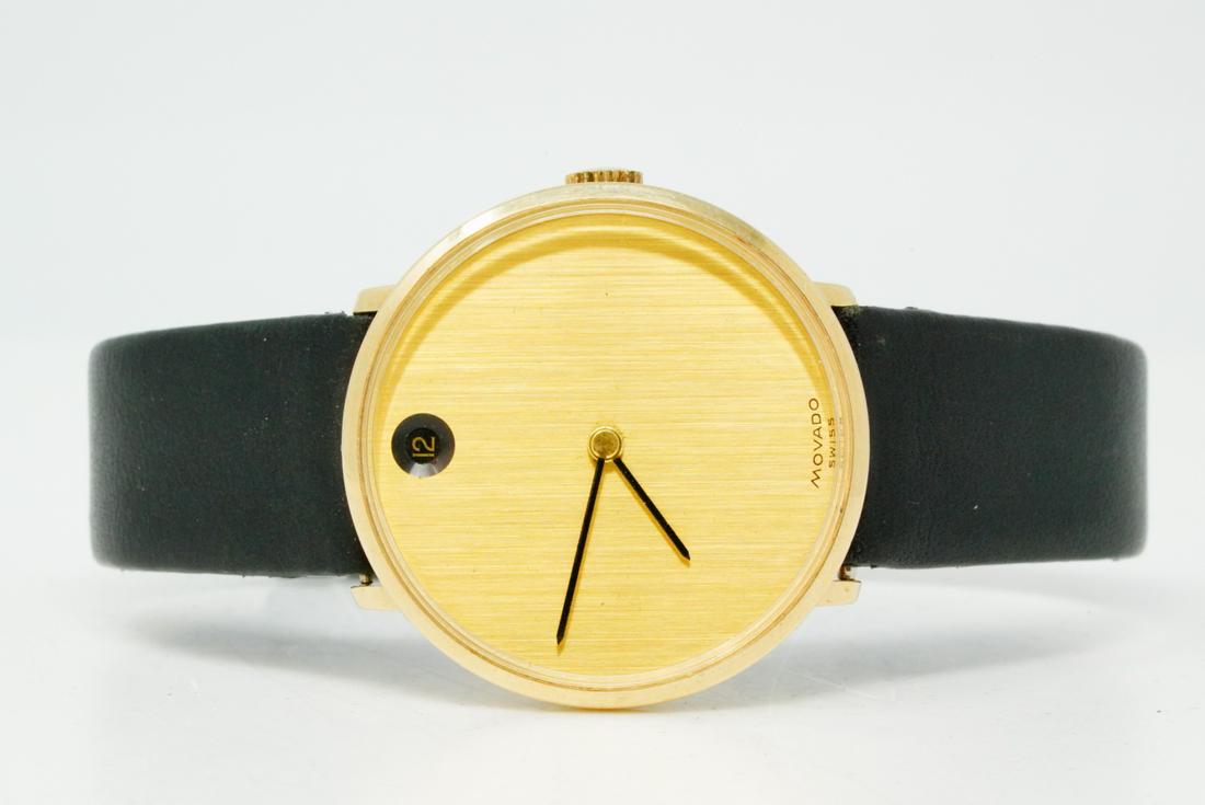 Movado 14K Yellow Gold Museum Date Watch: Movado Solid 14K Yellow Gold Museum Date Watch W/Black Leather Band - This lovely watch by Movado is the iconic Museum watch which features a clean and modern design with a 14k yellow gold round case,