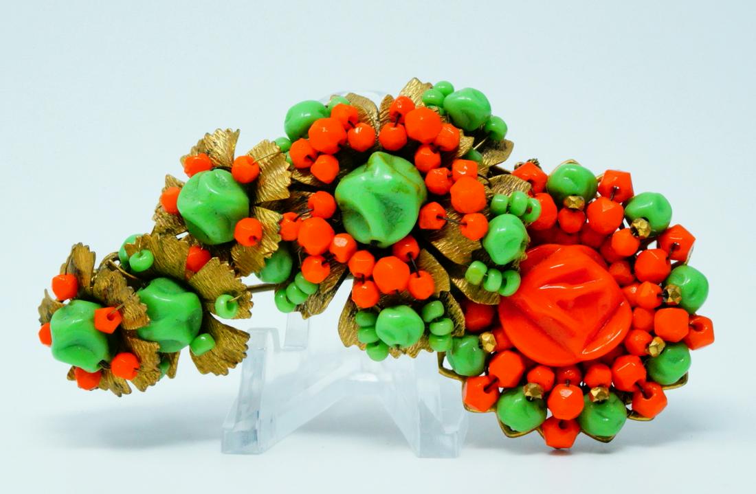 Miriam Haskell Vintage Beaded Gold Tone Brooch: Miriam Haskell Vintage Beaded Gold Tone Brooch - This lovely gold-colored brooch by Miriam Haskell is decorated with richly colored green and orange beads and textured details. The brooch has an ornat