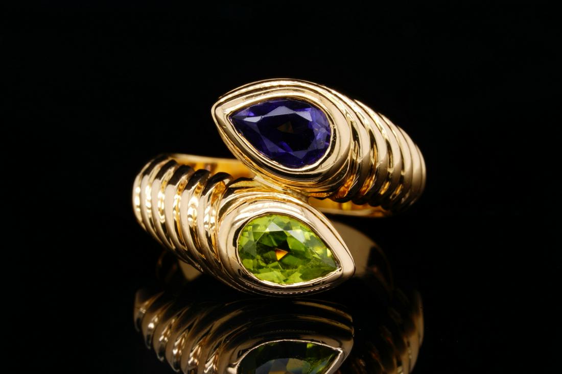 Bvlgari 1.00ctw Iolite & Peridot 18K Doppio Ring: Bvlgari 1.00ctw Iolite & Peridot Solid 18K Yellow Gold Doppio Bypass Ring - This lovely ring by Bvlgari was finely crafted of solid 18k yellow gold and is a retired design from the designer's Doppio c