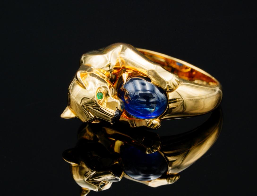 Cartier Panthere Blue Sapphire, Emerald, 18K Ring: Cartier Panthere Collection Blue Sapphire Cabochon Solid 18K Yellow Gold Ring W/Emerald & Onyx Accents - This superb piece by Cartier is from the brand's iconic and instantly recognizable Panthere col