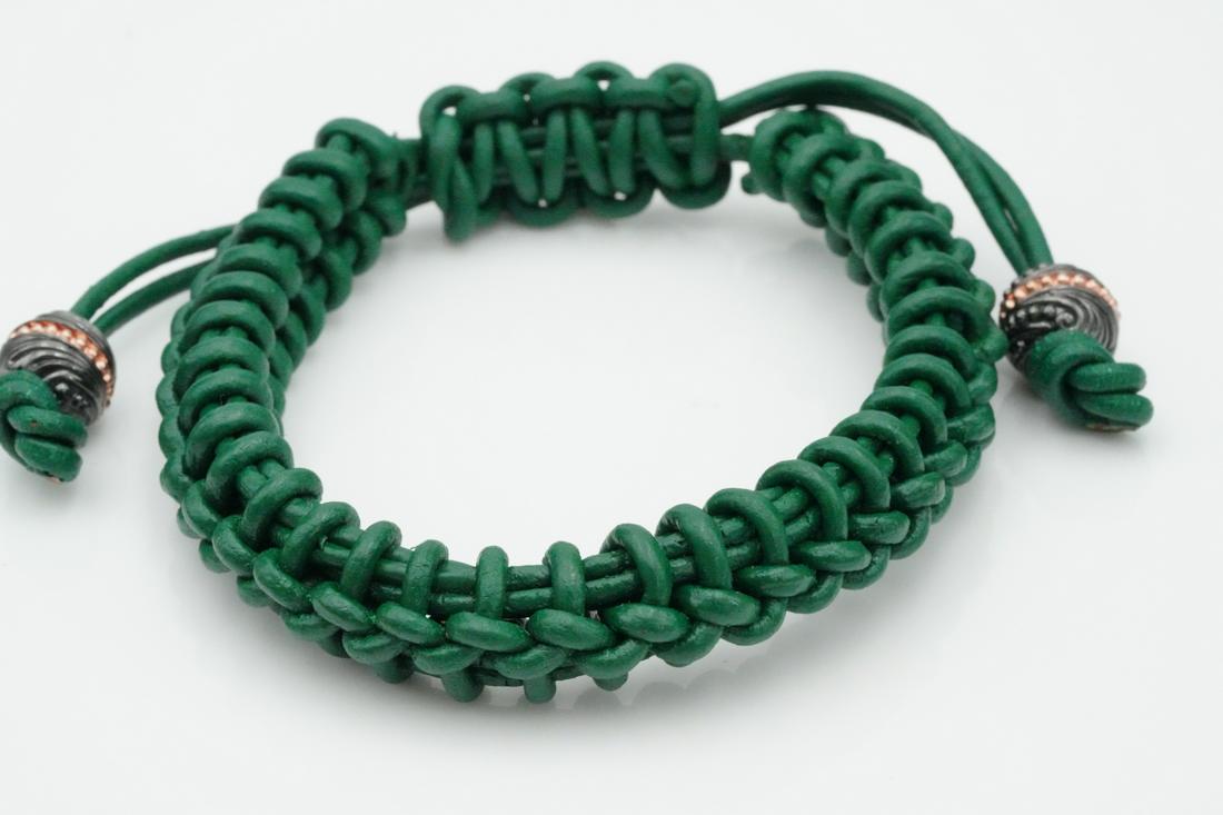 Stephen Webster No Regrets Woven Leather Bracelet: Stephen Webster No Regrets Woven Green Leather Bracelet - This woven green leather bracelet comes from Stephen Webster's No Regrets collection. The bracelet has an adjustable design and silver tipped