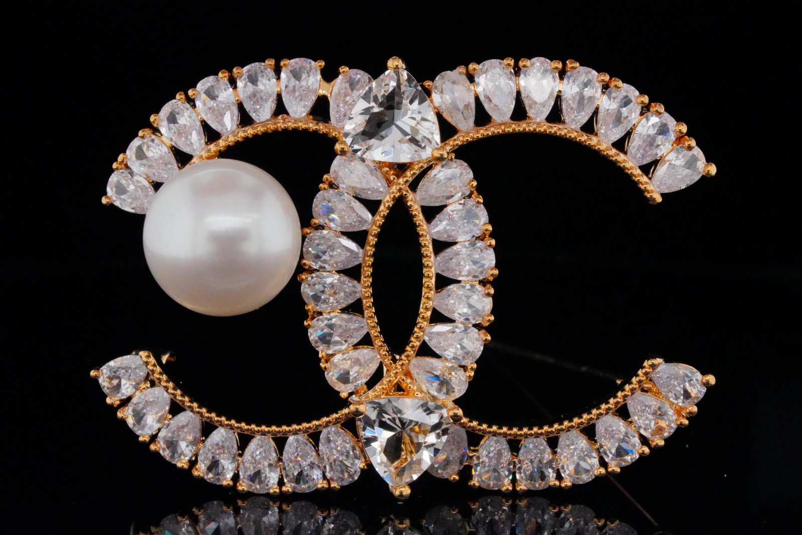 12mm Genuine Pearl and Pave Crystal Fashion Brooch: 12mm Genuine Pearl and Crystal Gold Tone Fashion Brooch - This lovely fashion accessory is gold colored and has a CC logo design embellished with fiery white crystals and a genuine 12mm pearl. Measure