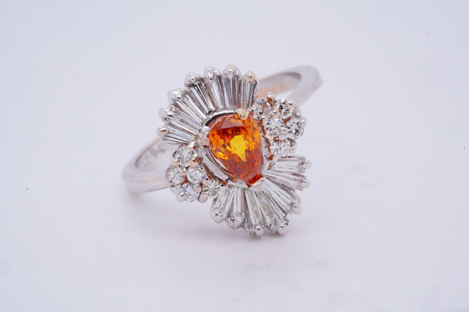 1.20ctw Brown and White Diamond 14K White Gold Ring: 1.20ctw Brown and White Diamond 14K White Gold Ring - This ring is crafted of 14k white gold and boasts a 0.50ct (approximate) pear cut brown-orange diamond center stone. The center stone is surrounde