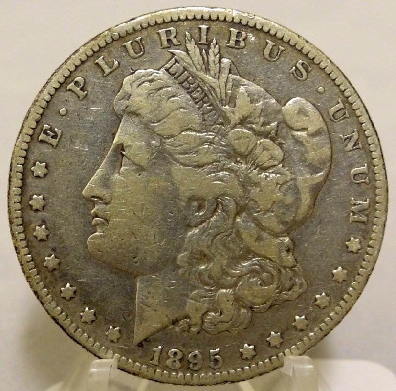 1895-O Morgan Silver Dollar *Key Date*: Mintage: 450,000. This is an ultra rare find with strong detail, and clear reeding. The obverse is in full view, and reverse shows VF20 detail.