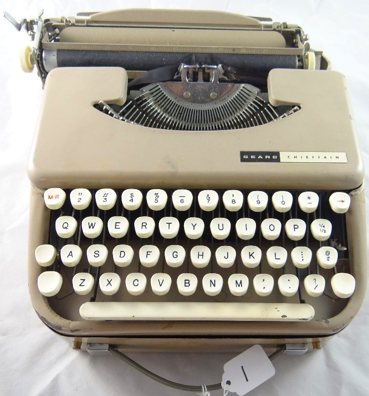 Vintage Sears Portable Typewriter W/Case: Vintage Sears "Chieftain" Portable Manual Typewriter W/ Hard Case. The piece appears to be working. All of the keys move freely & the piece is in good condition. The typewriter is tan in color. This i