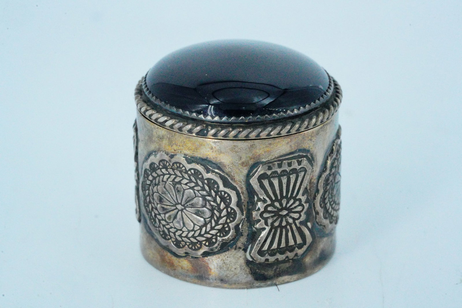 Native American Sterling Silver and Onyx Pill/Trinket Box: Native American Sterling Silver and Onyx Pill/Trinket Box (Signed) - This trinket or pill box is crafted in sterling silver with an onyx cabochon on the lid. Hallmarks: RTT. Measurements: 1.10" x 1.10