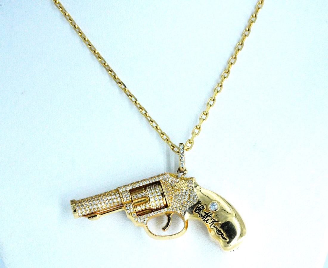 1.25ctw Diamond 18K Revolver Necklace W/Rotating Chamber: 1.25ctw SI1-SI2/G-H Diamond and 18K Yellow Gold One of a Kind Signed Designer Revolver Pendant Necklace W/Rotating Chamber - This one of a kind designer piece is crafted in 18k yellow gold. The neckla