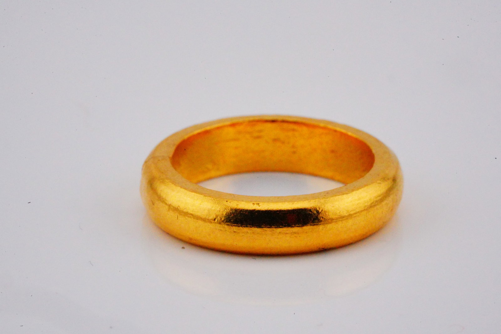 24K Yellow Gold 5.7mm Wide Band: 24K Yellow Gold 5.7mm Wide Band - This gold band was finely crafted of solid 24k yellow gold and has a very heavy and luxurious feel. The ring was purchased by our seller in Dubai at the gold market e