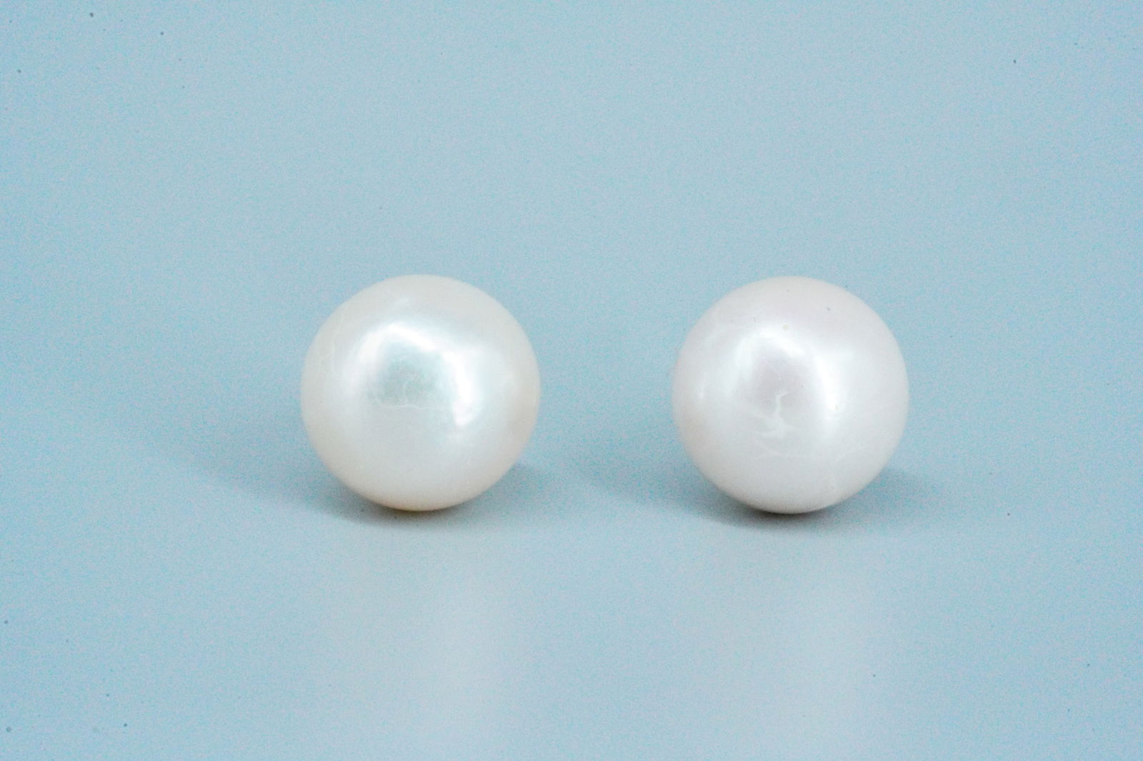 14mm Pearl and 18K Yellow Gold Stud Earrings: 14mm Pearl and 18K Yellow Gold Stud Earrings - These beautiful stud earrings boast 14mm pearls finished with 18k yellow gold posts. The pearls have a lovely spherical shape and shiny iridescent luster