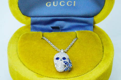 Gucci Flora 1.00ctw Diamond, Sapphire 18K Skull Necklace: Gucci Flora 1.00ctw Diamond and Blue Sapphire and 18K White Gold 23" Skull Pendant Necklace W/Box - This lovely piece from Gucci's Flora collection features a meticulously crafted skull pendant