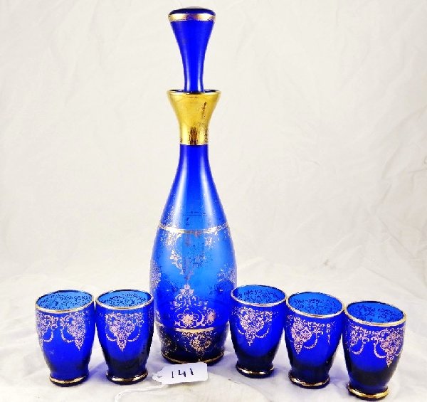 Vintage Liquor Decanter Set W/5 Glasses: This is a beautiful blue glass liquor decanter with 5 shot glasses. The pieces have lovely gold designs on them. All of the pieces are in great condition. The decanter is approx. 12" & the glasses app