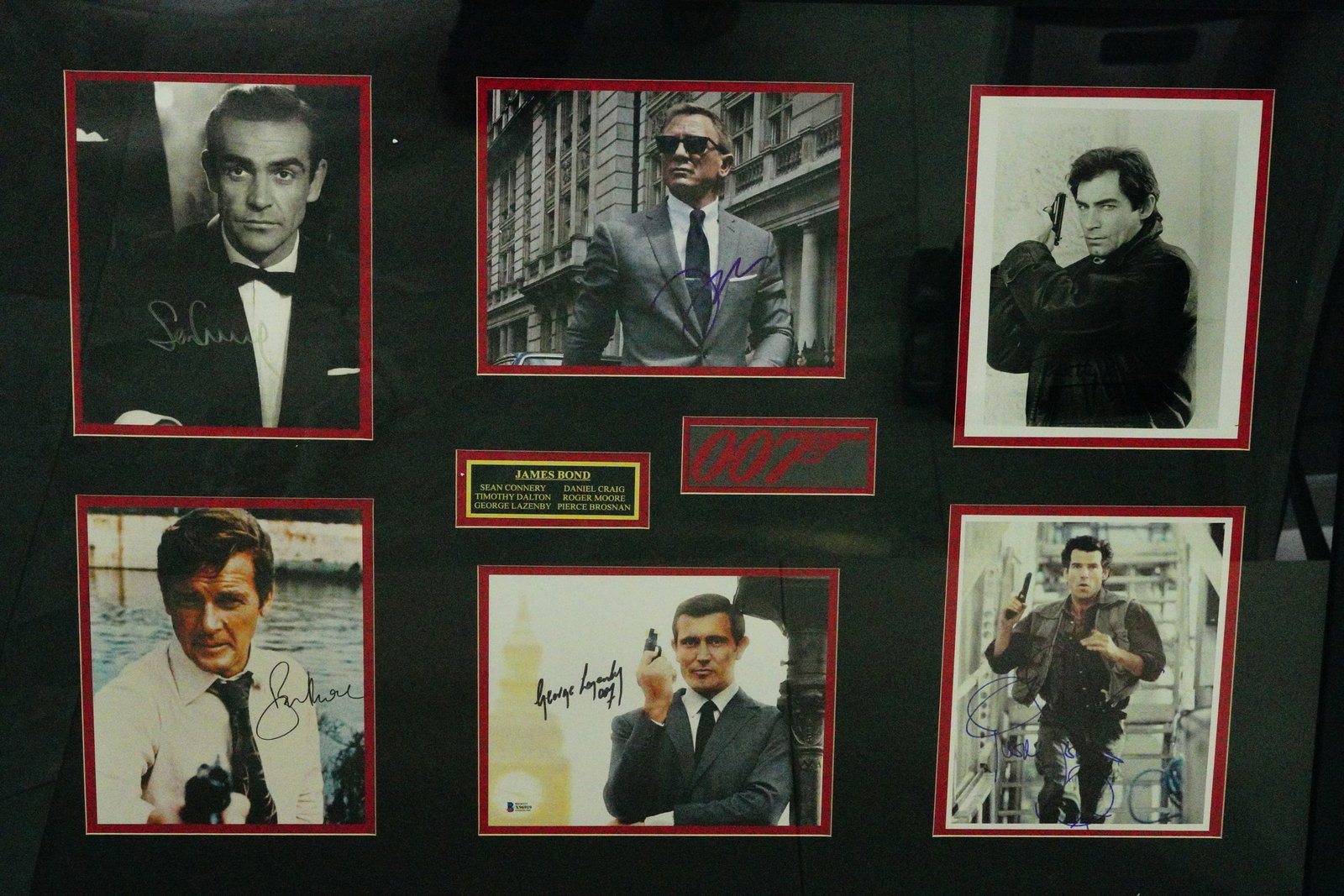 James Bond Autographed Photo Display W/(6) Actors: James Bond Framed Autographed Photo Display Signed by (6) Bond Actors (Sean Connery, Pierce Brosnan & Others) W/(6) COAs - This framed signature display contains autographed photos of the six main act