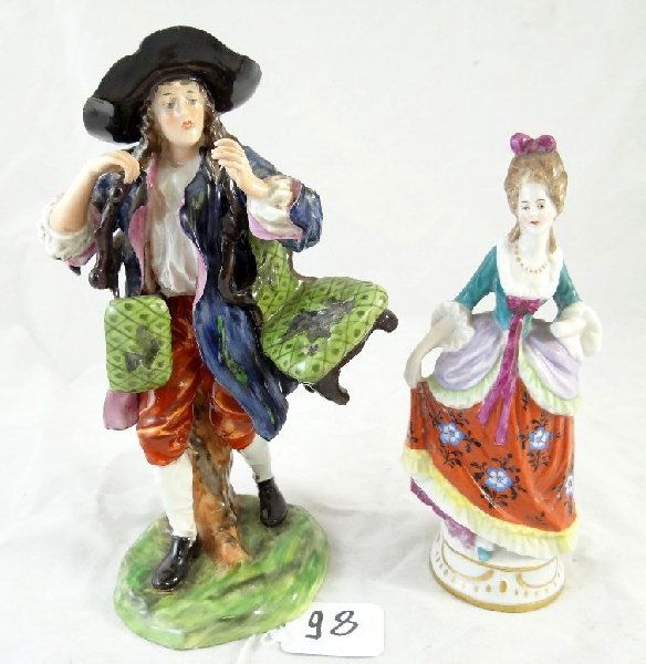 Lot of (2) Vintage Capodimonte Figurines: Both pieces are marked with a Crown N back stamp. Both pieces are in good condition, except for a chip on the lady's hand, and the man that carries chairs has 1 broken chair leg. Other chair leg repai