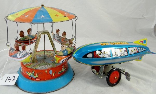 Lot of (2) Vintage Tin Toys: There is one Sky Rangers wind up blimp toy & one carnival ride toy. They are in good condition.