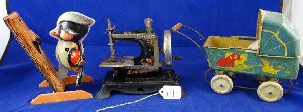 Lot of Antique & Vintage Tin toys & More: This lot includes an antique baby carriage with a porcelain baby inside a miniature antique sewing machine & a vintage wood pecker toy & measure approximately 6"-7"