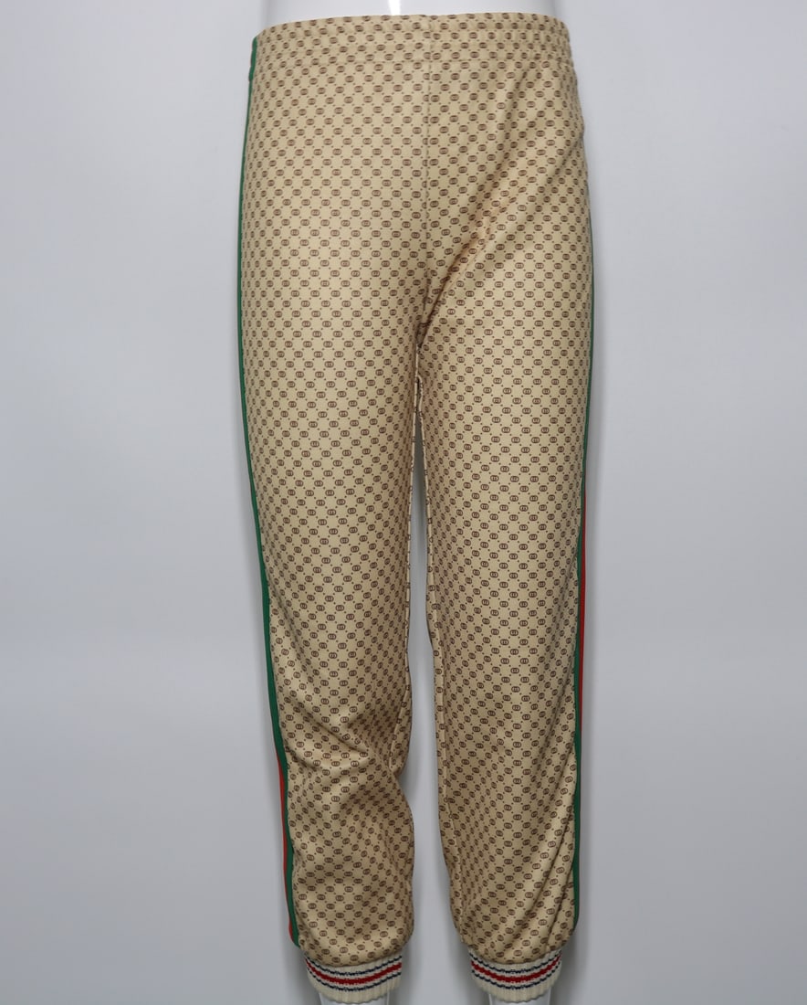 Gucci Children's Print Track Joggers?with Stripes: GUARANTEED AUTHENTIC. Gucci Children's Print Track Joggers?with Stripes - The Gucci Children's Print Track Joggers are a statement piece that combines comfort with iconic Gucci style. These joggers fe