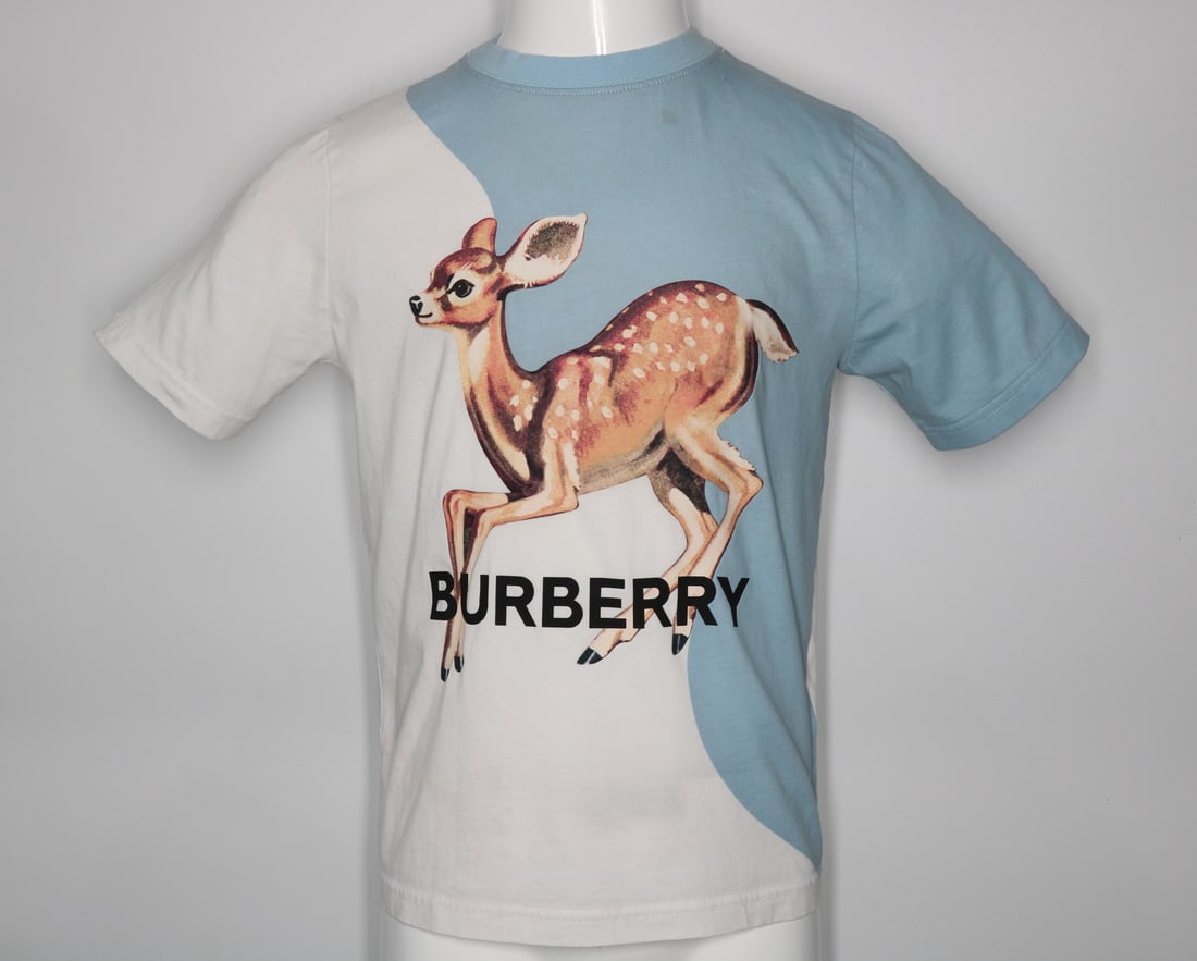 Burberry Children's Deer White and Blue T-Shirt: GUARANTEED AUTHENTIC. Burberry Children's Deer Cotton White and Blue T-Shirt - This two-tone t-shirt features a white and blue design, complemented by a round collar and short sleeves for a classic an