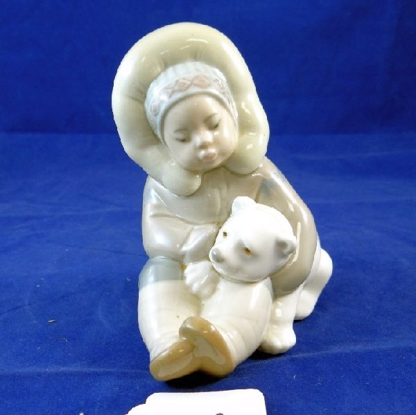 Vintage Porcelain Eskimo Figurine: This vintage figurine displays a eskimo child holding a polar bear cub measures approx 5"