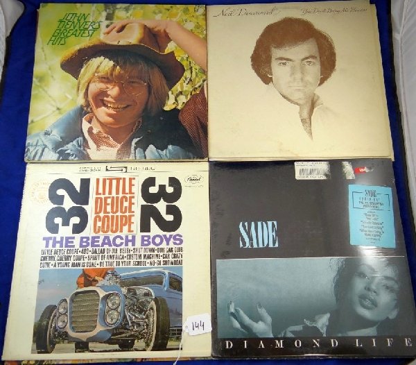 Lot of (12) Vintage Records: This lot includes records by "Niel Diamond 1972 You don?t bring me flowers" The Beach Boys Little Duece Coupe" 1973 John Denvers greates hits" "1985 sade Diamond life record" never been opened