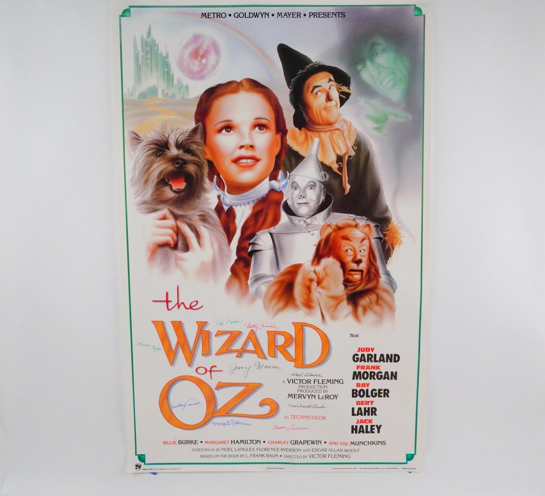 The Wizard of Oz Movie Poster Signed by Munchkins: The Wizard of Oz 34x22-Inch Movie Poster Reprint Signed by (9) Munchkins W/COA - This is a 34x22-inch color movie poster reprint featuring art from the beloved 1939 MGM production, "The Wizard Of Oz".