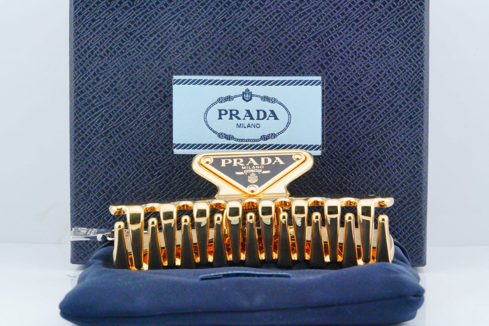 Prada Gold Metal Hair Clip W/Box (Never Used): Prada Gold Metal Hair Clip W/Box (Never Used) - The Prada Gold Metal Hair Clip is a luxurious and stylish accessory that adds an elegant touch to any hairstyle. Crafted from high-quality gold metal, t