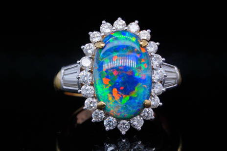 3.62ct GIA Black Opal, 1.10ctw Diamond and 18K Ring: 3.62ct GIA Certified Black Opal, 1.10ctw VS1-VS2/G-H Diamond and 18K Yellow/White Gold Ring - This ring is crafted in 18k yellow gold and boasts an approximately 3.62ct GIA certified natural black opa
