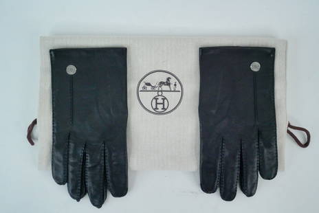 Hermes Black Lambskin Gloves W/Dust Bag: Hermes Black Lambskin Gloves W/Dust Bag - These Hermes gloves are crafted in saddle-stitched glossed buttery soft lambskin with 100% silk lining and silver Clou de Selle detail. Includes: dust bag. Co