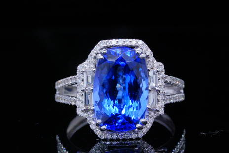 6.50ct Tanzanite, 1.00ctw Diamond and 18K Ring: 6.50ct Tanzanite, 1.00ctw VS1-VS2/G-H Diamond and 18K White Gold Ring - This stunning ring is crafted in 18k white gold and boasts an approximately 6.50ct oval cut tanzanite. The tanzanite displays an