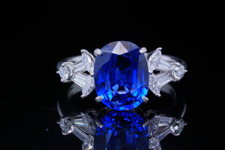 4.50ct Blue Sapphire, 0.60ctw Diamond, Platinum Ring: 4.50ct Blue Sapphire, 0.60ctw VS2-SI1/G-H Diamond and Platinum Ring - This beautiful ring is crafted in platinum and boasts a 4.50ct (approximate) oval cut blue sapphire. This high quality sapphire is