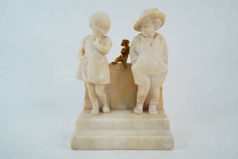 Antique Carved Alabaster Children with Gilt Cherub: Antique Carved Alabaster Figural Group, Children with Gilt Bronze Cherub - This is a charming antique carved alabaster sculpture featuring a young girl and boy standing on a stepped base, flanking a s