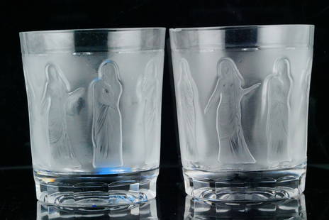 Lot of (2) Lalique "Femmes" Frosted Crystal Tumblers: Lot of (2) Lalique "Femmes" Frosted Crystal Tumblers - An elegant pair of Lalique crystal tumblers in the coveted Femmes pattern, featuring a continuous frieze of frosted female figures in flowing rob