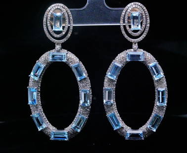 20ctw Aquamarine, 3.80ctw Diamond and Silver Earrings: 20.00ctw Aquamarine, 3.80ctw Diamond and Silver 2.5" Drop Earrings - These earrings are crafted in silver and are embellished with approximately 20.00ctw emerald cut aquamarines. The earrings are also