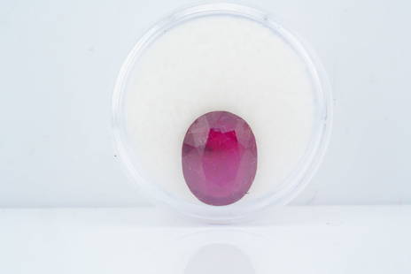 8.35ct Oval Cut Ruby: 8.35ct Oval Cut Ruby - A substantial loose ruby weighing approximately 8.35 carats. This oval-cut gemstone features a rich red hue with translucent clarity. The stone exhibits a faceted surface and me