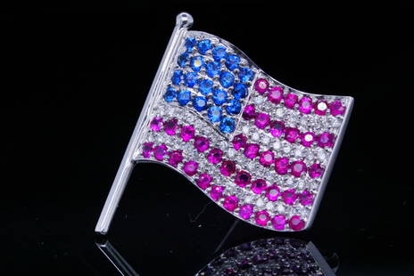 2.25ctw Ruby, Blue Sapphire, and Diamond 18K Flag Pin: 1.25ctw Ruby, 0.50ctw Blue Sapphire, 0.50ctw Diamond and 18K White Gold Flag Pin - This brooch is crafted in 18k white gold and has a lovely design in the form of an American flag. The brooch is embel